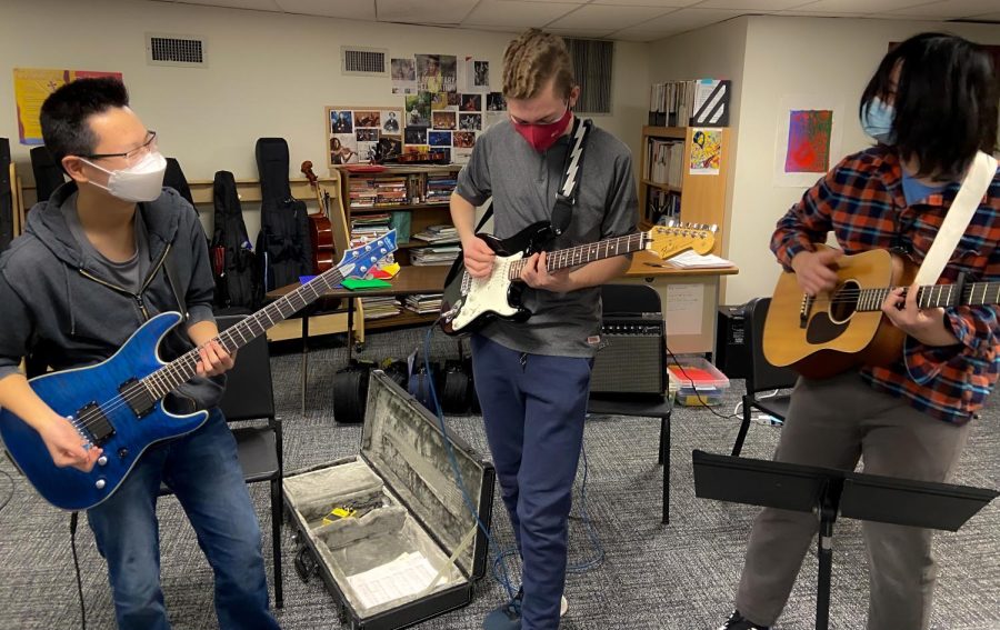 William Ju ‘23, Campbell Lee ‘23, and lead guitarist Christian Sun ‘23 circle together while playing guitars for the song The Only Exception by Paramore. These guitarists focus on establishing a singular sound, trying to work on simultaneous strumming and accents. 