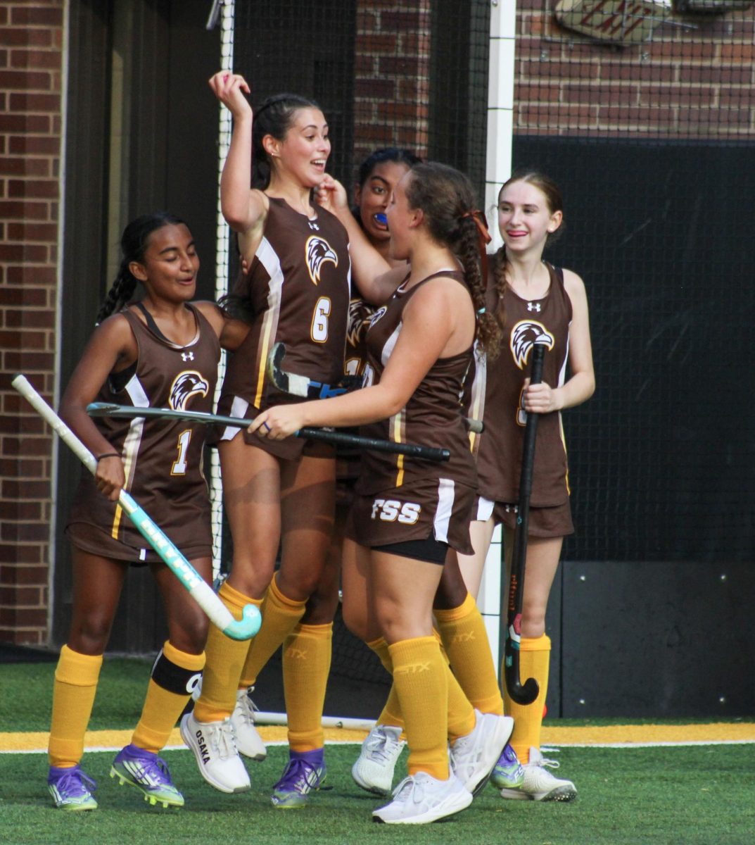 The Field Hockey team celebrating a goal.