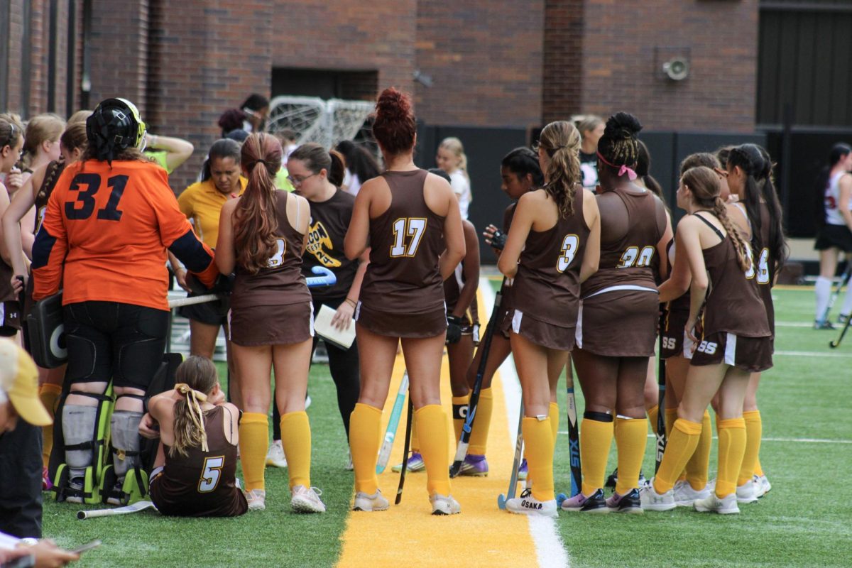The field hockey team pre-game, going over their game plan.