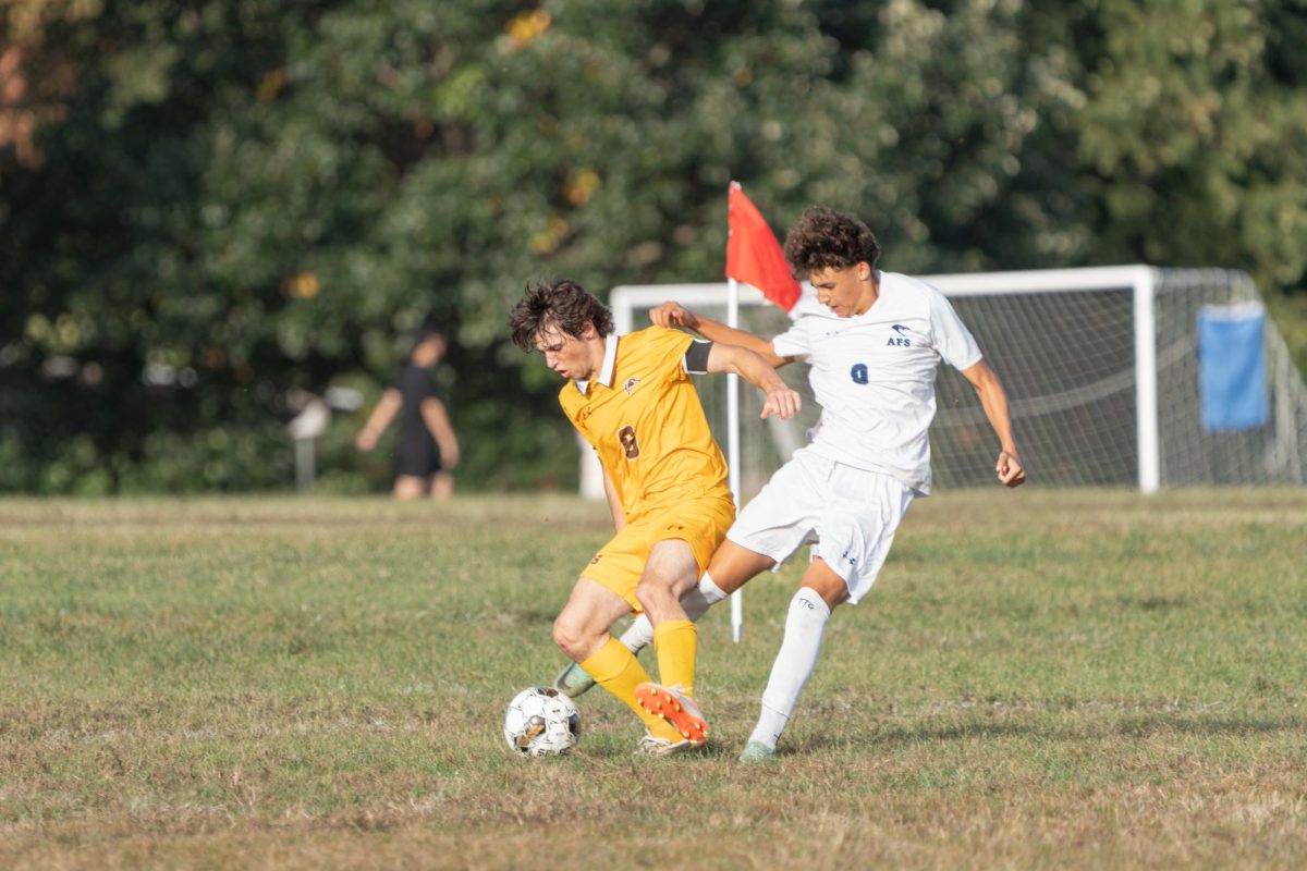 Jake Fogg '26 defending a close goal.