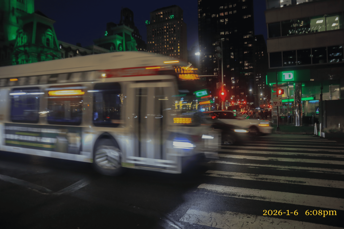 Rush hour at City Hall of Philadelphia at 6:08 pm. There is a lot of movement, specifically an oncoming SEPTA bus heading westbound.
