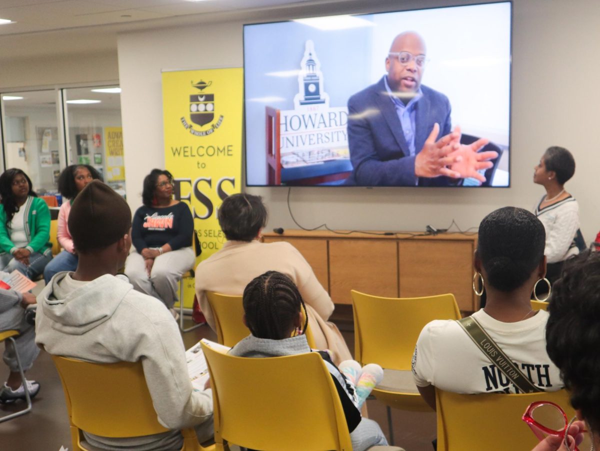 All attendees and panelists watching a video about Howard University.